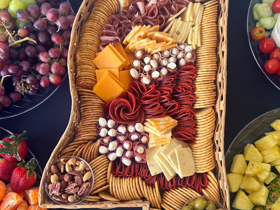 Catering tray shaped like the state of Mississippi, filled with meats, cheeses and crackers